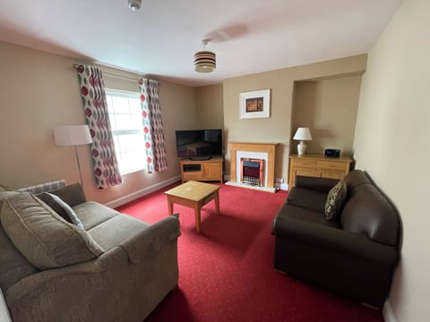 Family Suite, 2 Bedrooms, Kitchen | Living area | 65-inch Smart TV with digital channels, TV, iPod dock