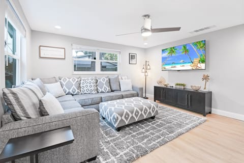 Living room features a 65" Smart TV along with a Roku & a very comfortable couch