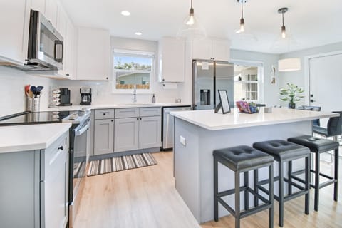 Fully stocked kitchen w/ all your cooking needs plus an island w/ seating for 3