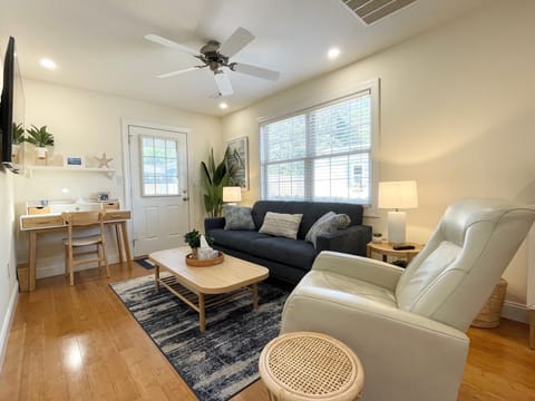 Living room with couch, recliner, and large Smart TV.