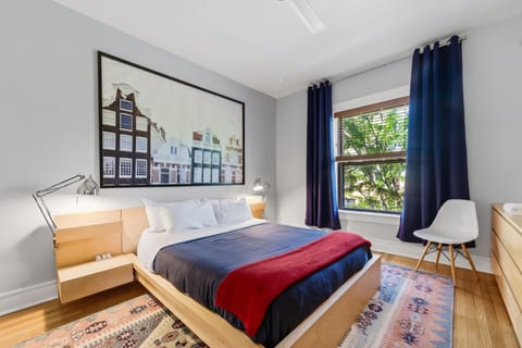 Spacious primary bedroom with a comfortable queen bed and ceiling fan.