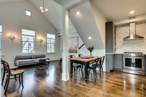 When you arrive, the main floor is open - living room, dining table, and kitchen all share a bright room with cathedral ceilings