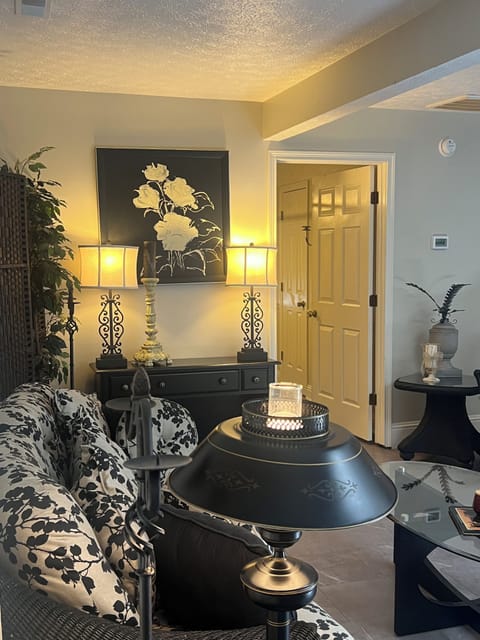 Open living/dining with skylight, styled in chic gray, black, cream & white