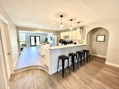 Kitchen with breakfast bar and pendant lights