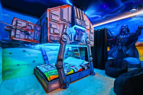 Epic Star Wars-themed bunk room with glowing lights and galactic wall art.