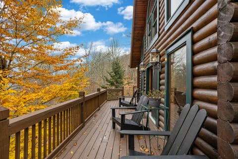 Wrap Around Deck with Adirondack Style Seating and Fall Color View