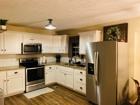 Full kitchen with dinnerware, drinkware, with some seasonings and spices