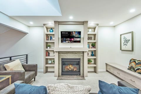Modern comfort meets classic charm in this living room with a fireplace and TV.