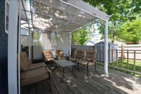 Private outdoor patio seating in the back yard and cornhole 