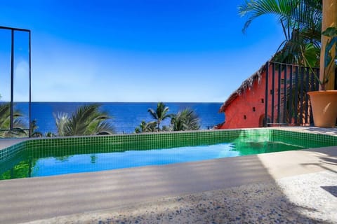 Solar heated dipping pool and view of village below