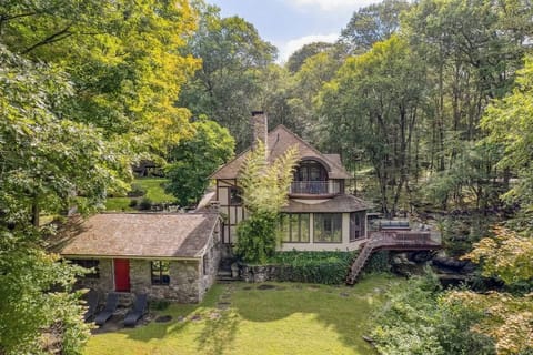 A private riverfront estate set across 3.5 acres, where two streams wrap around