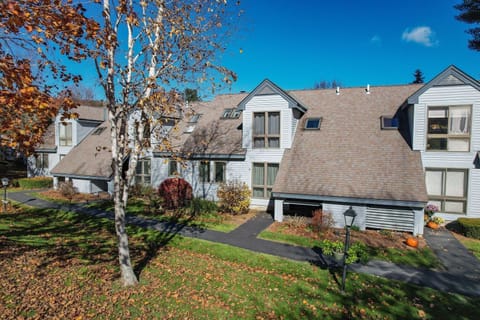 Lakeland Village 5B exterior with birch tree and autumn landscaping