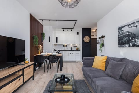 A stylish living room with a grey sofa and modern decor.
