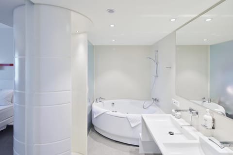 Suite, 1 King Bed (Additional Living Area) | Bathroom | Rainfall showerhead, free toiletries, hair dryer, heated floors