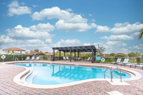The clubhouse pool with sun loungers is the perfect spot on a hot day.