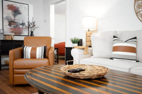 Living area. Sofa, 3 chairs, fans, dining table