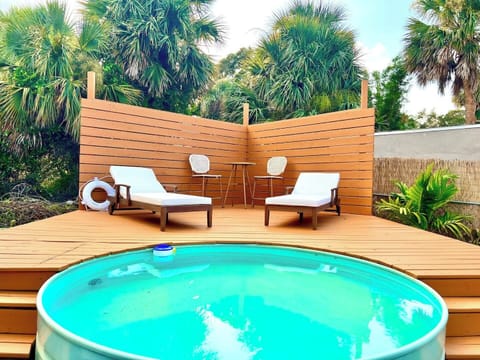 Backyard oasis with putting green, cowboy pool, covered porch, hammock and outdoor furniture!