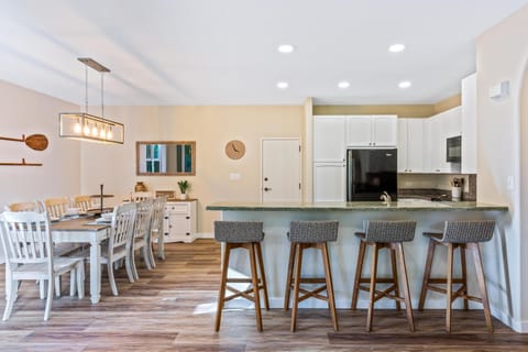 Full kitchen with breakfast bar, granite counters, and modern appliances