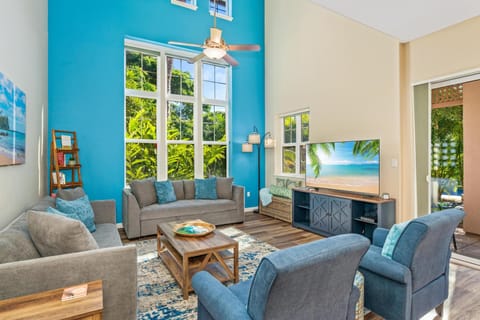 Spacious, bright living room with vaulted ceilings and tall windows