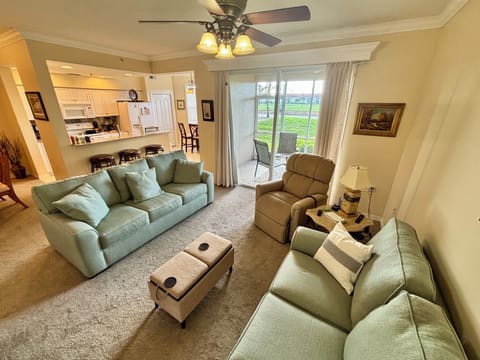 Spacious open concept living room and kitchen overlooking the 17th fairway of Cypress Woods CC!