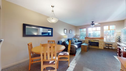 Bright living area with large windows and gas fireplace