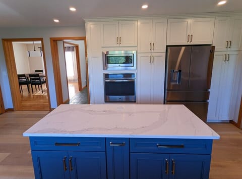 Newly renovated kitchen with 5 burner gas range and electric oven.