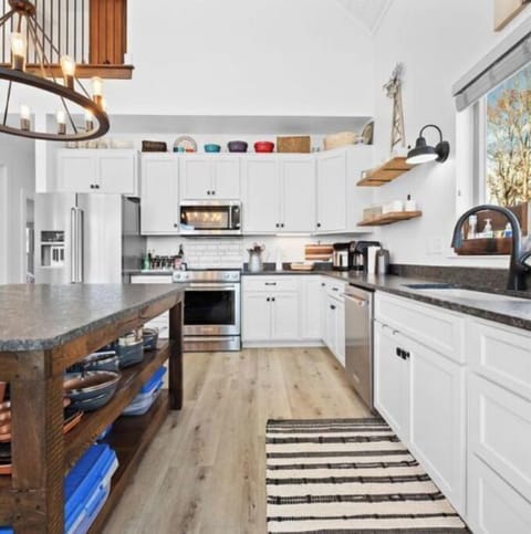 Kitchen area, numerous utensils for meal preparation.