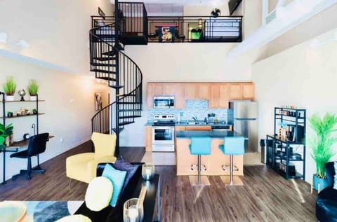 Capture the kitchen's charm and the elegant spiral staircase guiding you to the loft in one delightful snapshot.





