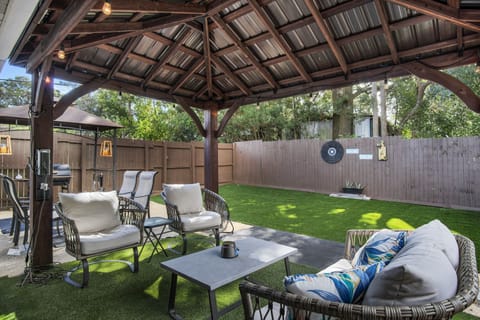 Relaxing outdoor area with lighted Gazebo, seating and fenced yard
