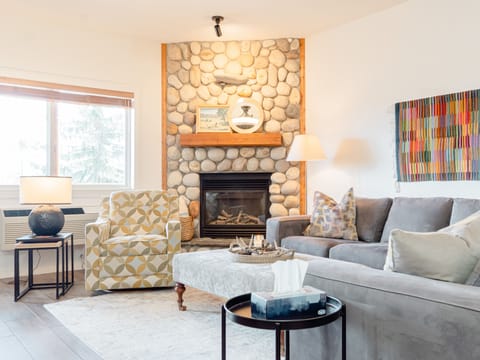 Living room with big comfy sectional and gas fireplace.