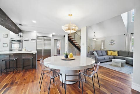 Table seats 8, with 5 bar stools at island.