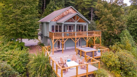 Two levels of outdoor living, Adirondack chairs, and a hot tub tucked into the Blue Ridge trees.