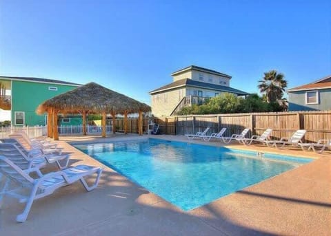 Community Pool — Tiki Hut, Lounge Chairs & Sparkling Blue Water