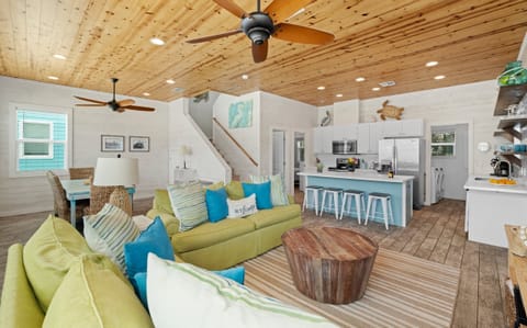 Open Plan Living — Green Sectional, Blue Kitchen Island & Pine Ceiling