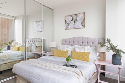 The master bedroom with a queen sized bed & plush pillows.