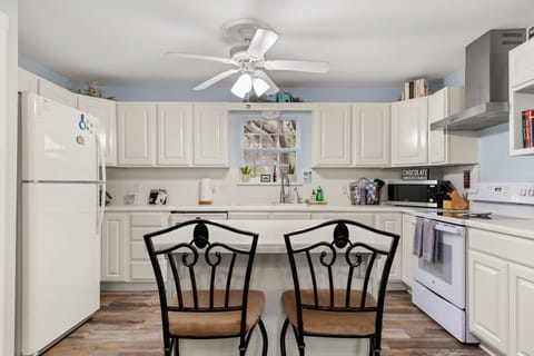 The barstool seating at the kitchen island, creates a cozy spot for conversations and shared moments.