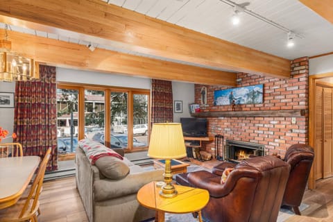 Relax and enjoy the views from the large living room windows while staying cozy in front of the wood fireplace.