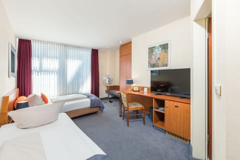 Standard Double or Twin Room | Minibar, desk, iron/ironing board, free cribs/infant beds