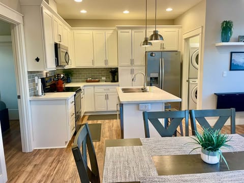 Kitchen with full size refrigerator, slab countertops Stainless appliances