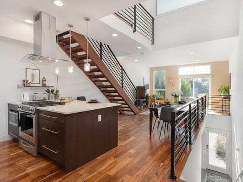 Living, dining and kitchen spaces with beautiful lofted ceilings 