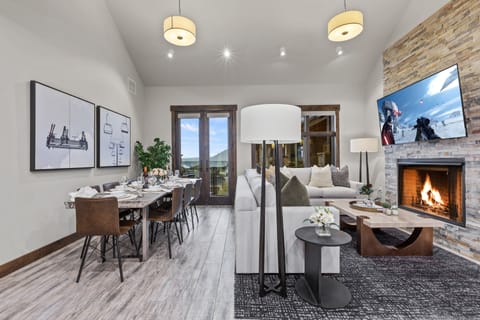 Contemporary furniture including a sectional sofa with sofa sleeper, a Smart TV, and a cozy gas fireplace. Step out onto the adjacent deck and you will also find outdoor furnishings and a BBQ grill.