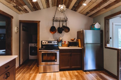 Full kitchen with amenities. Laundry room in the background.