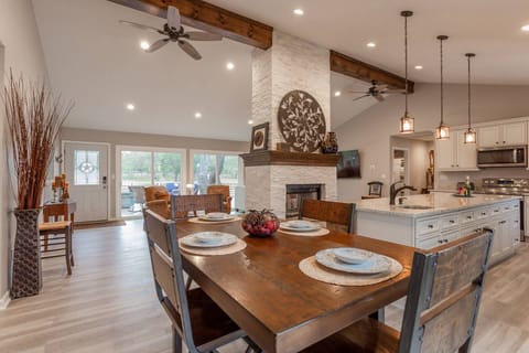 An abundance of space in this open concept living, dining, kitchen space, complete with a grand fireplace.
