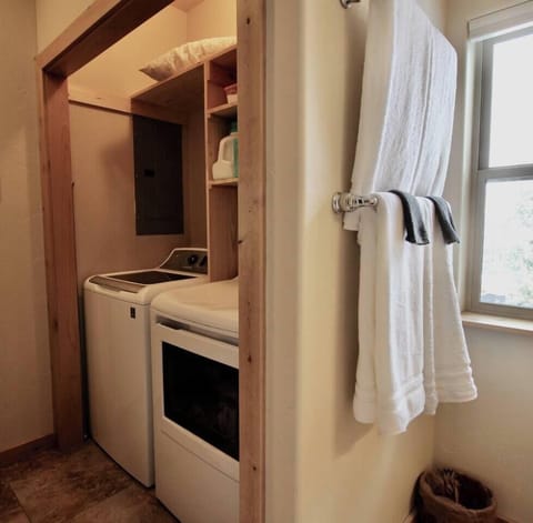 Step outside the bathroom and find the dedicated space for the laundry machines, providing easy access for your laundering needs.