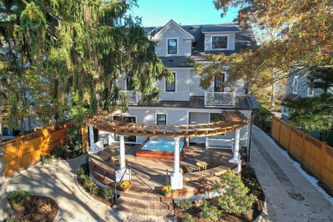 Back of house custom curved cedar pergola and curved ipe deck with built in 8 person hot tub.
Take a walk through the house on this link (copy and paste): https://newenglandhometours.com/70wrockave3du/