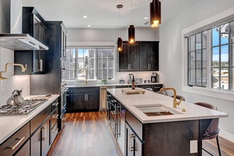 Beautiful Custom Cabinetry And High End Lighting Make This Kitchen A Dream To Cook and Entertain In