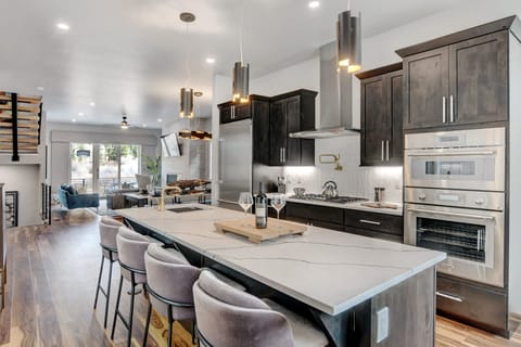 Island Area With Bar Sink, Wine Fridge, And Bar Seating For 4 People