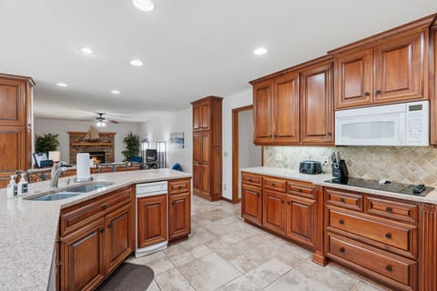Cook your favorite meals in this spacious gourmet kitchen featuring rich cherry cabinets, granite countertops, and modern appliances.
