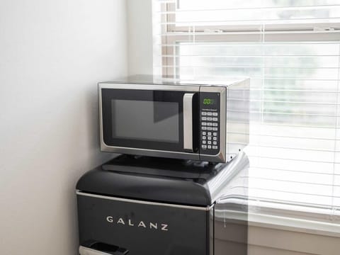 Space-saving yet mighty—this retro fridge & microwave keep snacks and meals handy.