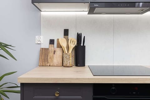 Modern kitchen detail with under-cabinet lighting and floral decor.
